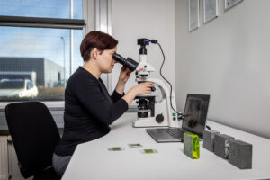 Carmen Batista Head of Laboratory at Y-MatTec is evaluating Ultra High Performance Concrete (UHPC) in a microscope